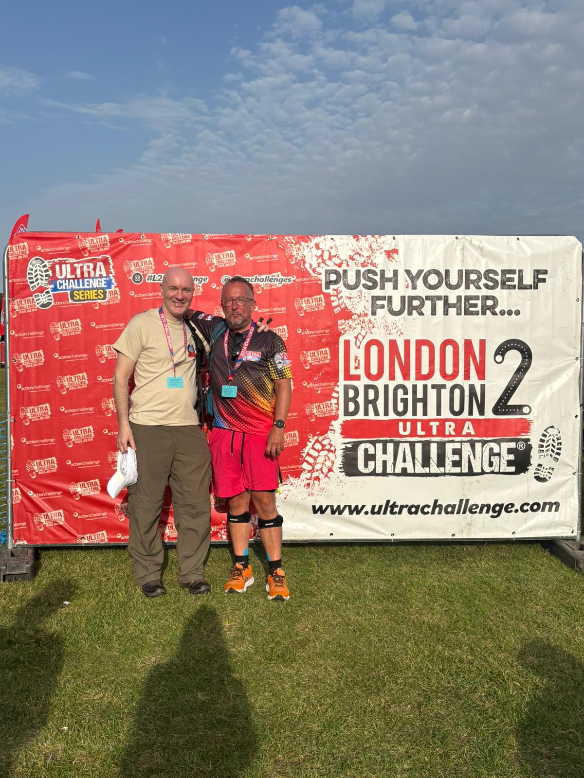 two men standing in front of a sign